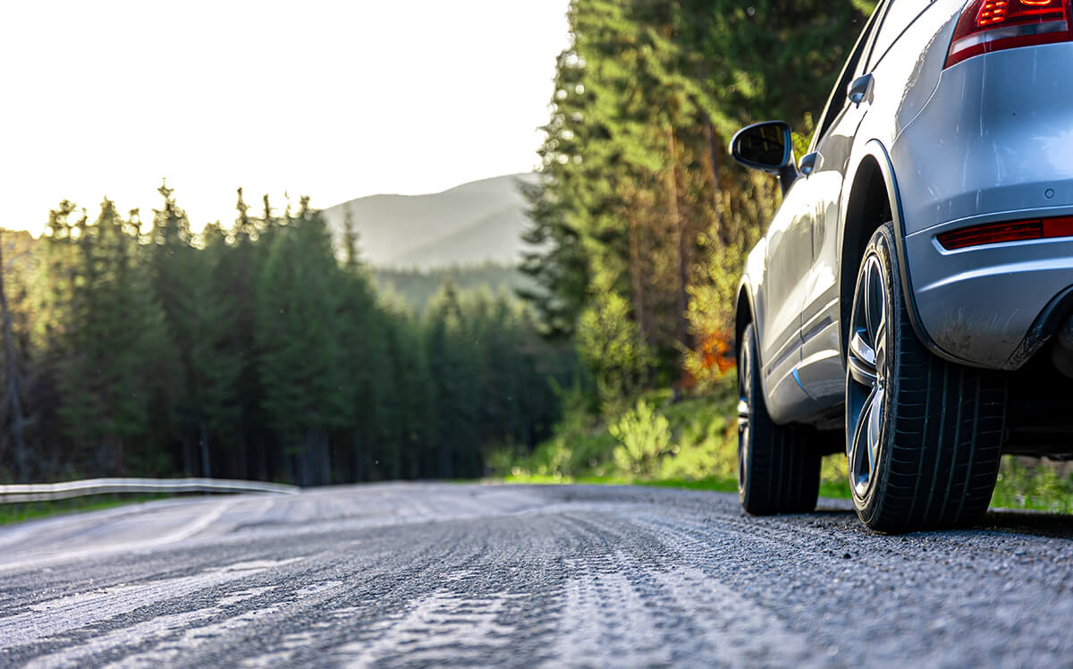 Car parked on a forest road in the mountains