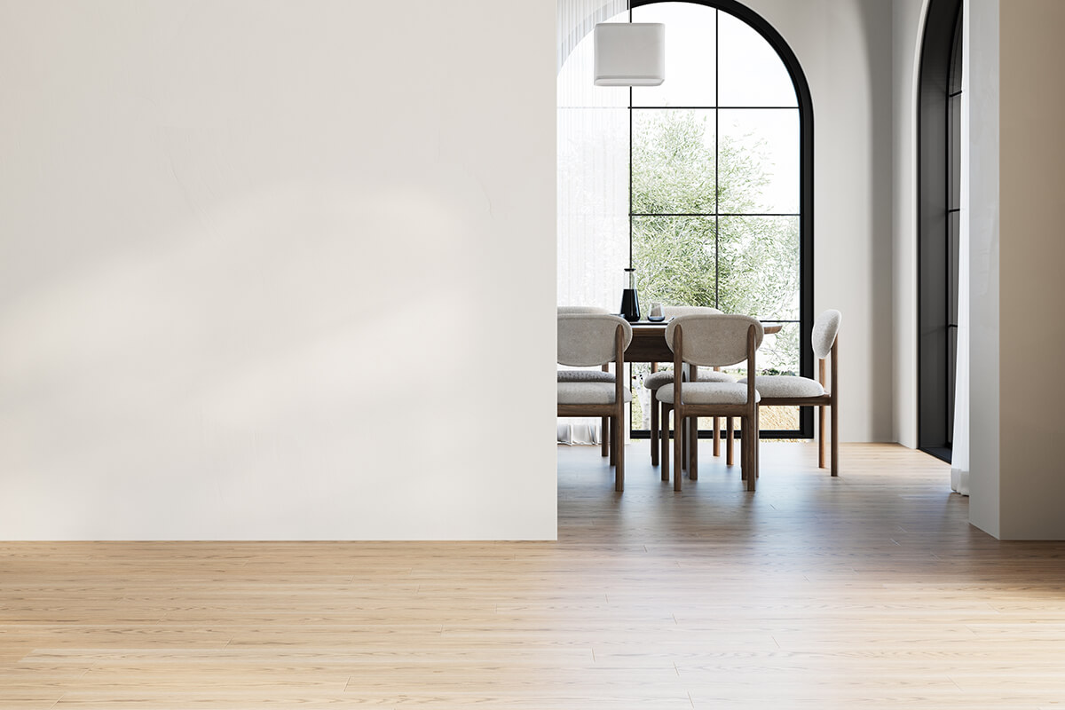 Dining room with upholstered chairs beneath an arched window