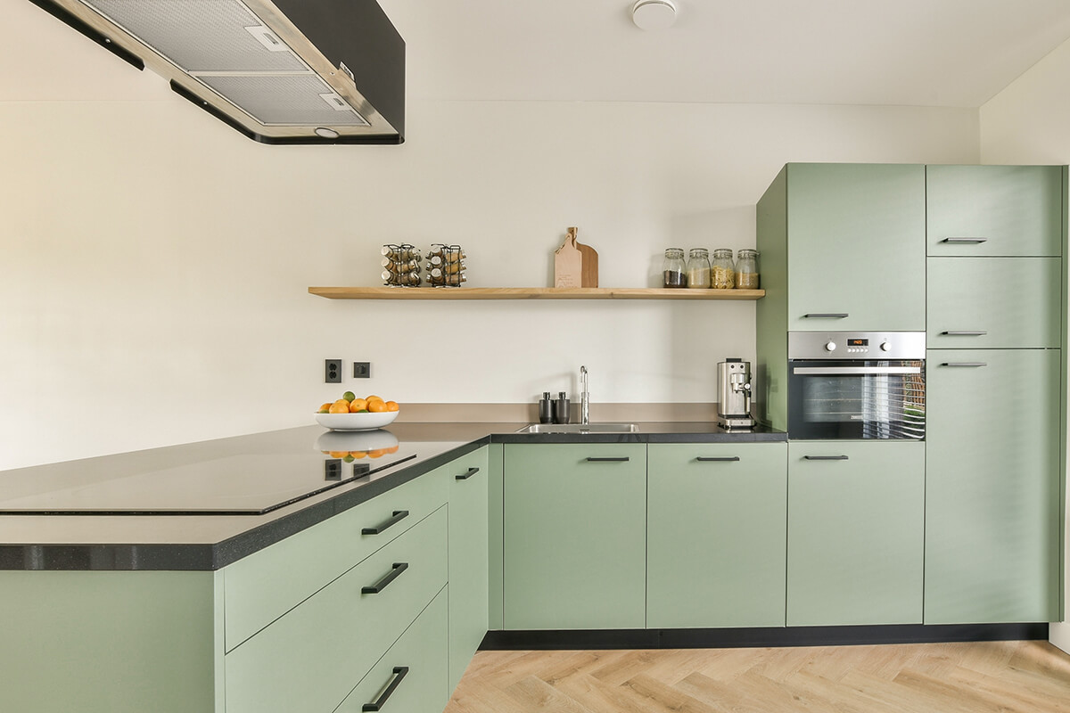 Modern fitted kitchen with built-in oven and induction hob