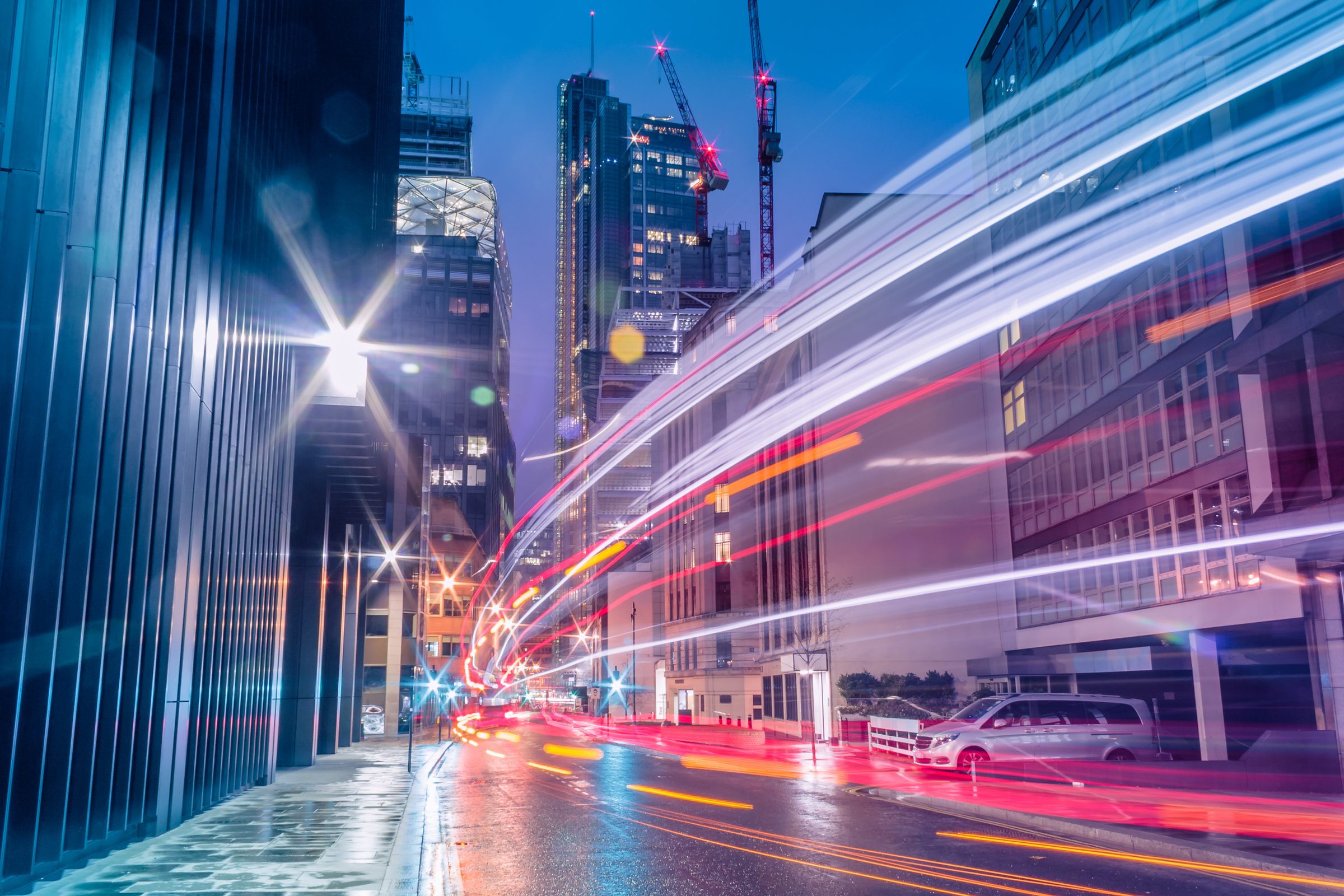 Light trails through a city at night, representing data in motion